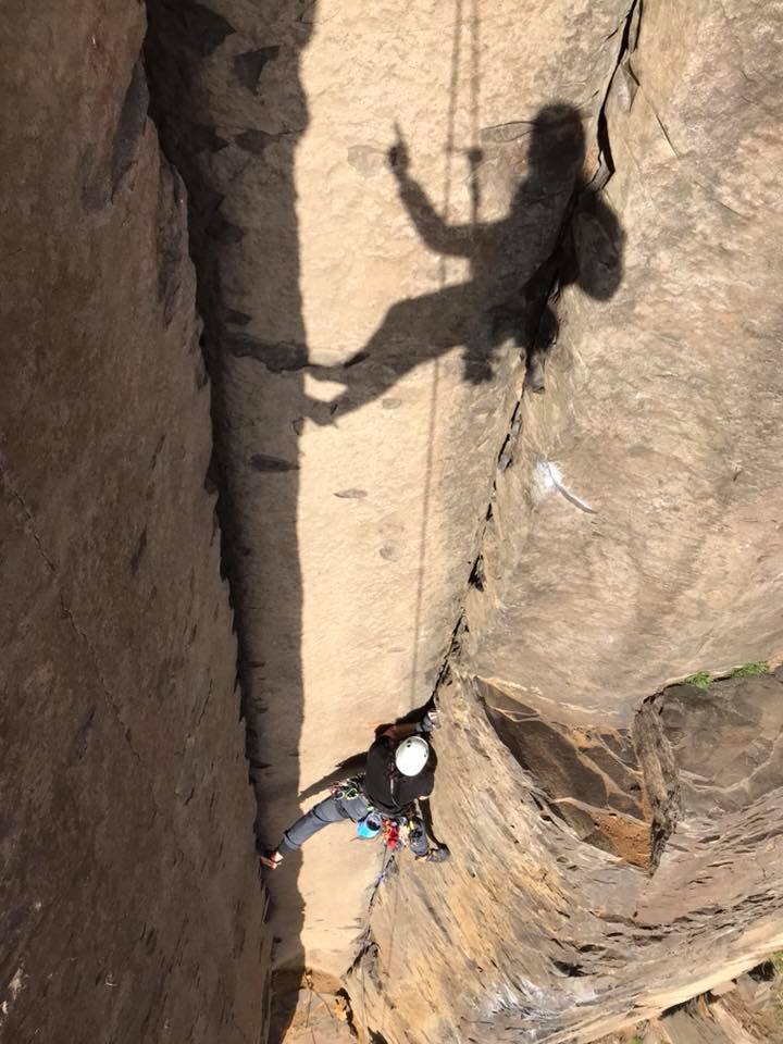 Climbing a corner and securing my safety line to the rock using traditional climbing gear - Vantage, Washington, USA
